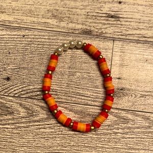Clay bead bracelet in red, yellow and orange.